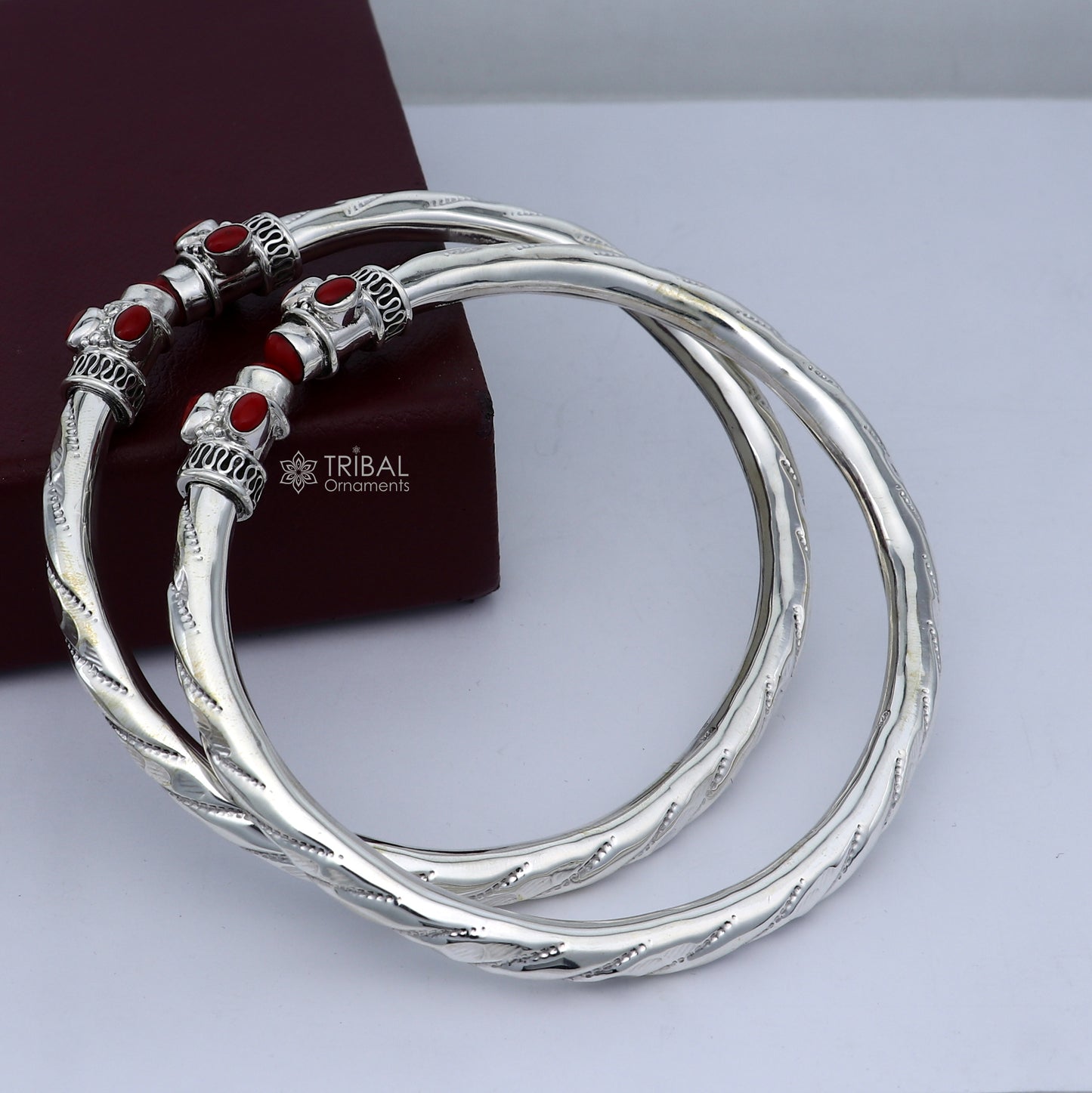 Sterling silver ankle kada bracelet with stylish design and a vibrant Coral stone, featuring intricate tribal ornament details.