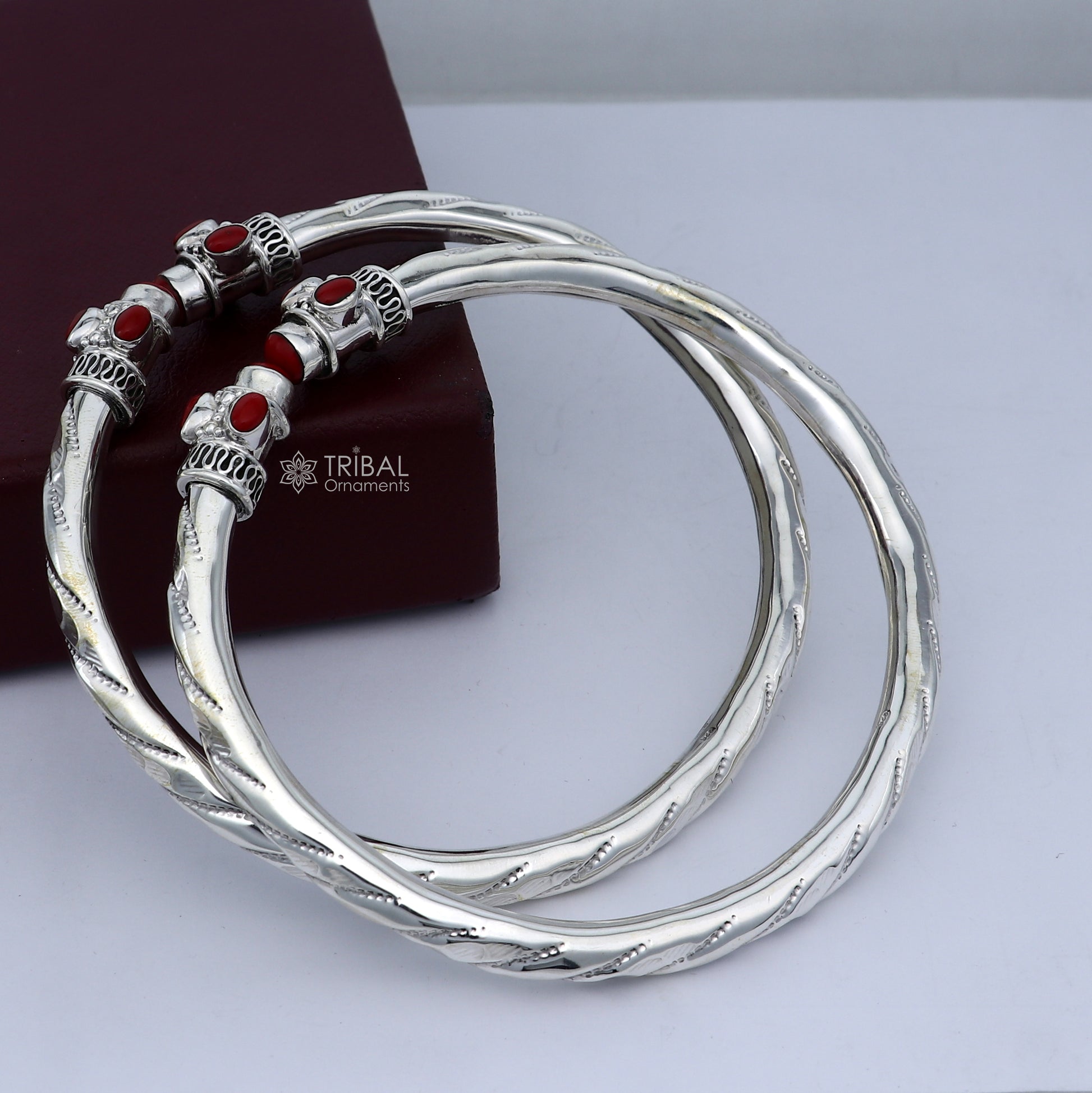 Sterling silver ankle kada bracelet with stylish design and a vibrant Coral stone, featuring intricate tribal ornament details.
