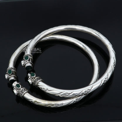 Sterling silver ankle kada bracelet with stylish design and green stone embellishment, featuring a tribal ornament style.