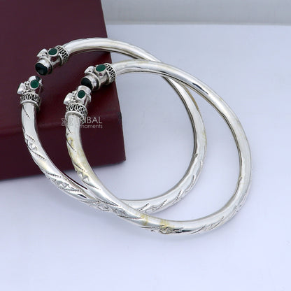 Sterling silver ankle kada bracelet with stylish design and green stone accent, showcasing intricate craftsmanship and elegant jewelry style.