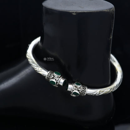 Sterling silver ankle kada bracelet with stylish design and green stone detail, featuring a traditional and elegant appearance.