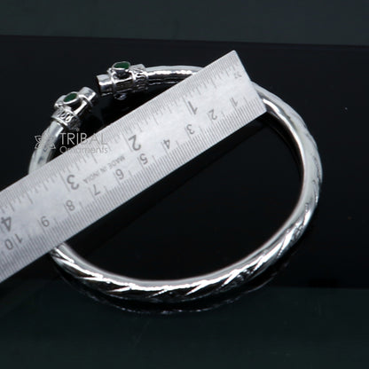 925 sterling silver ankle kada bracelet with a stylish design and a vibrant green stone, featuring intricate tribal ornament detailing.