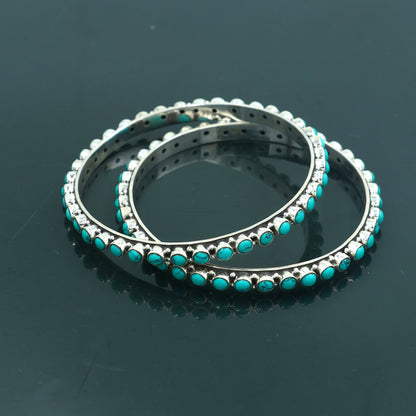 925 sterling silver bangle with turquoise stone from Tribal Ornaments, showcasing detailed craftsmanship and vibrant blue gemstone.