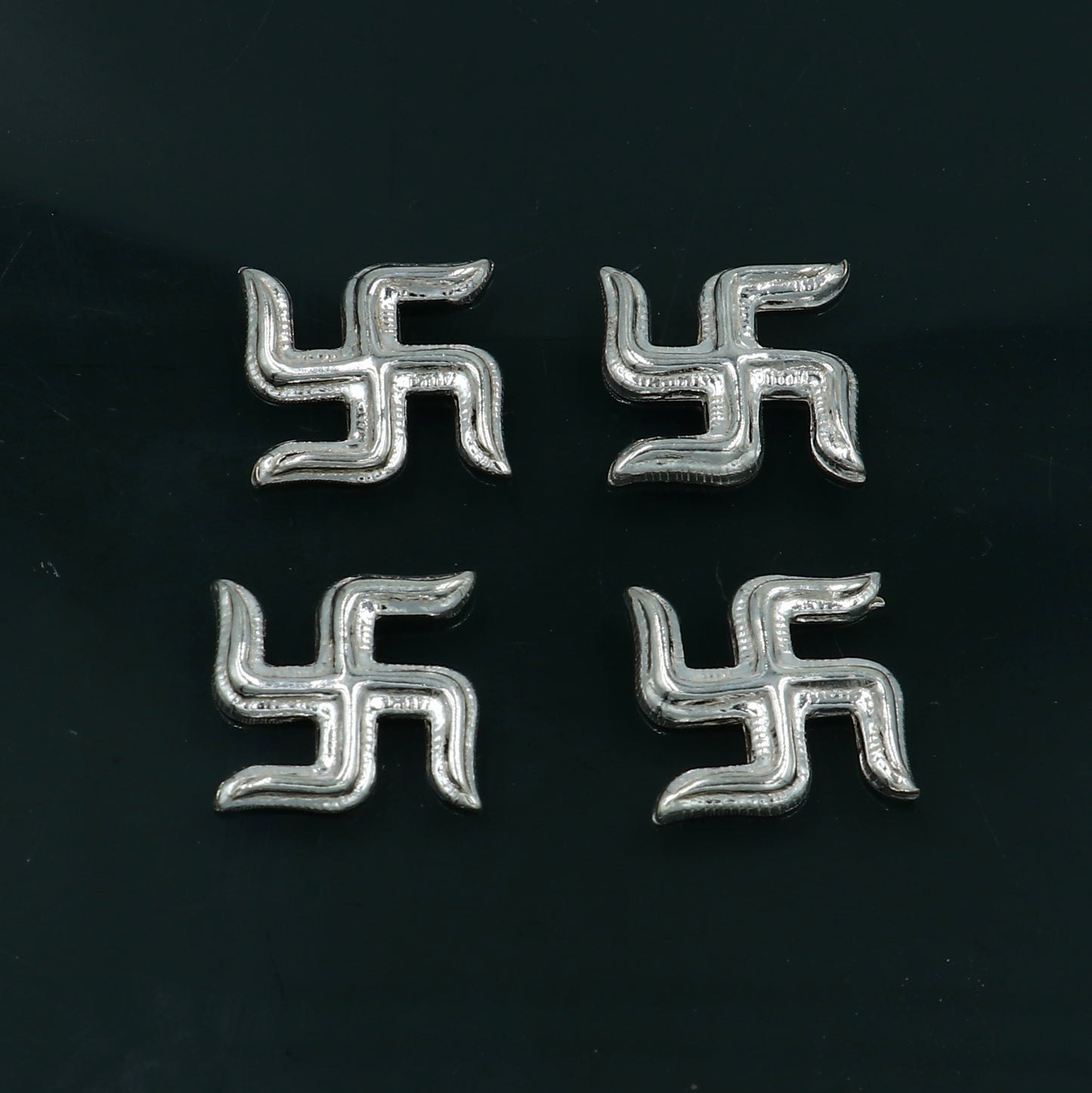 Tribal Ornaments 925 sterling silver Swastika Diwali pooja set with two decorative symbols for religious rituals.