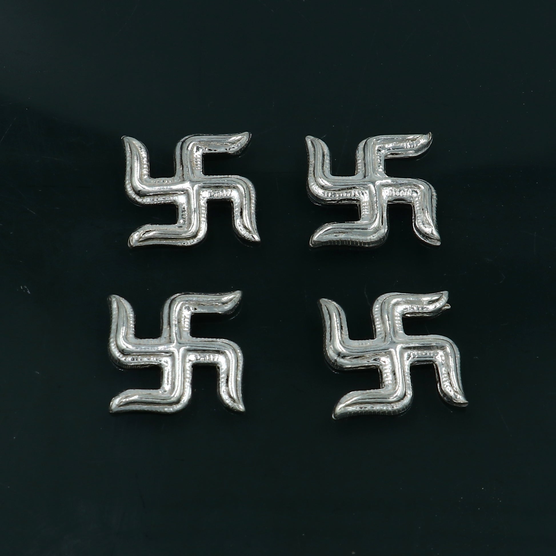 Tribal Ornaments 925 sterling silver Swastika Diwali pooja set with two decorative symbols for religious rituals.