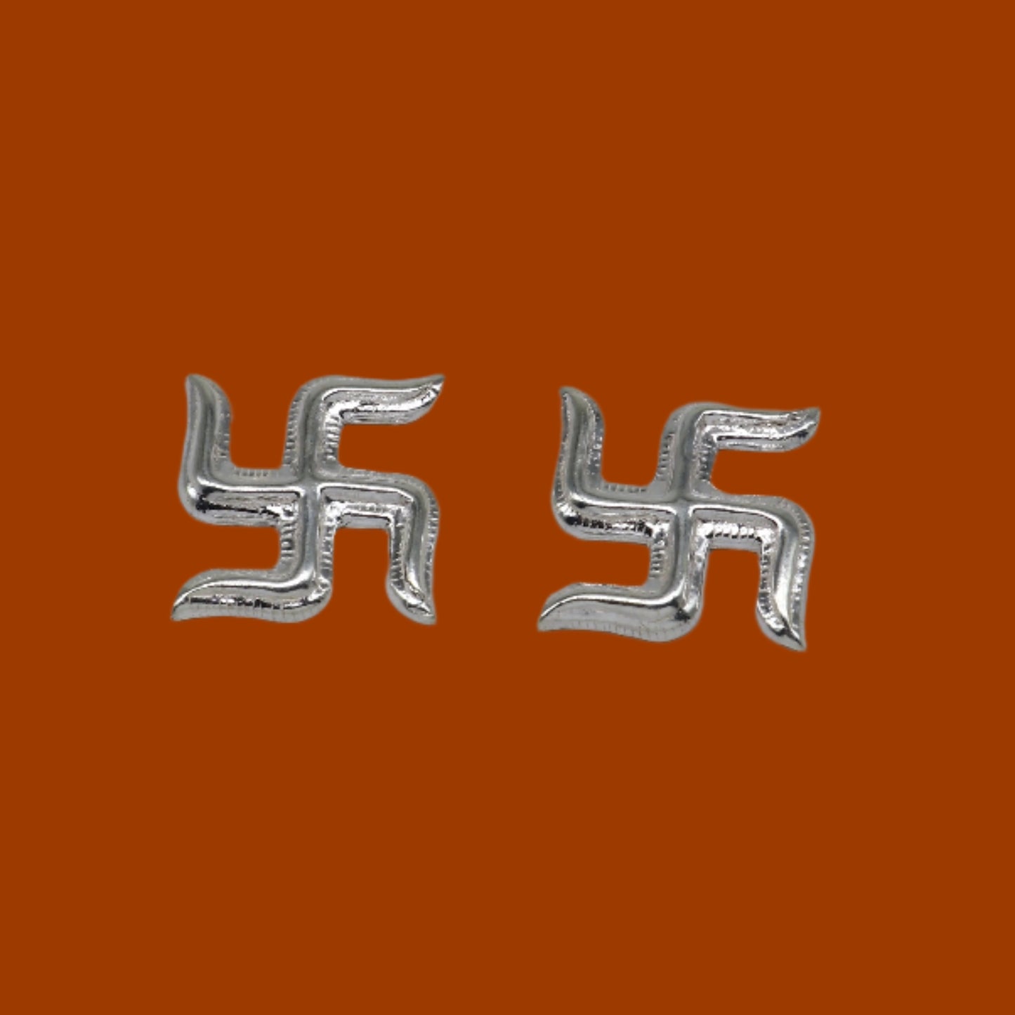 Two 925 sterling silver swastika symbols from Tribal Ornaments' Diwali pooja set, traditional silver religious decor.