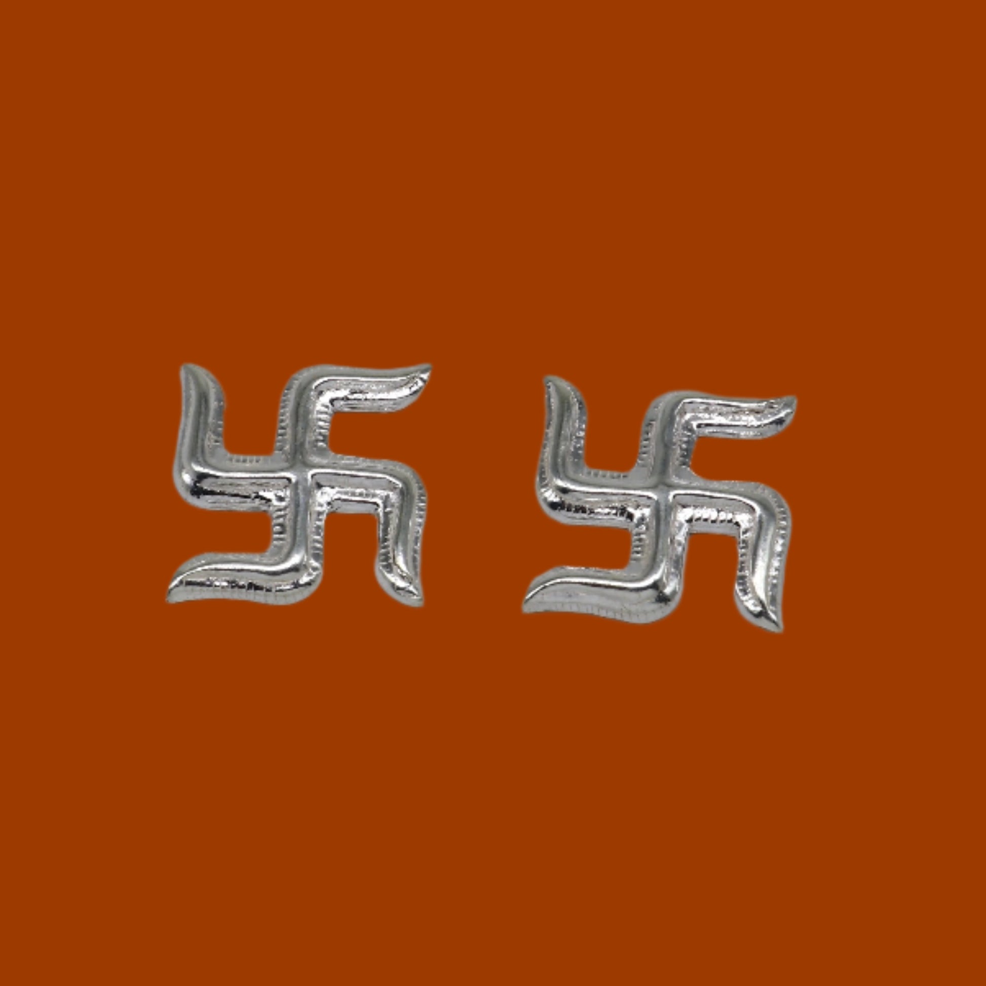 Two 925 sterling silver swastika symbols from Tribal Ornaments' Diwali pooja set, traditional silver religious decor.