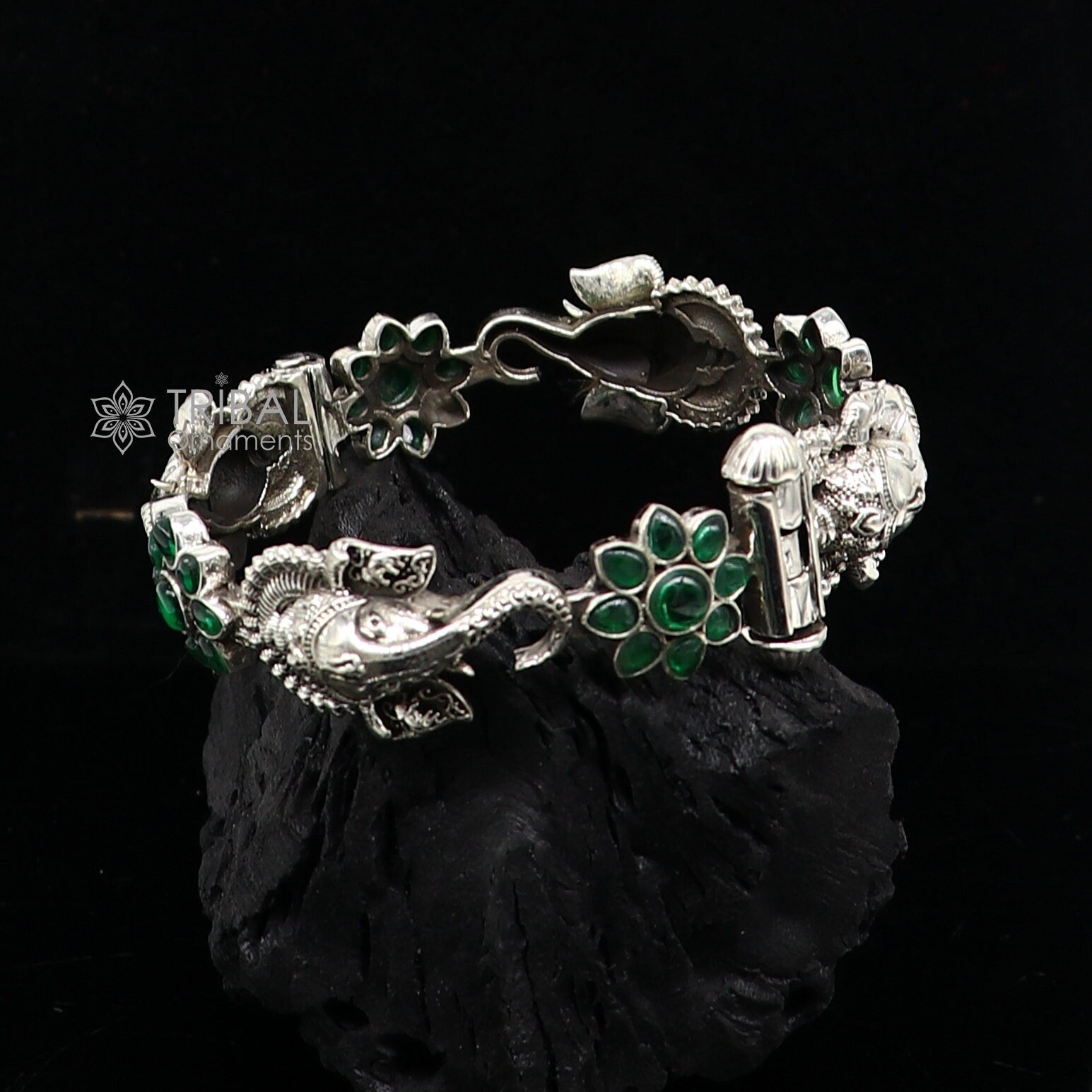 No 57 Opulent silver bracelet floral pattern with green outlets stones