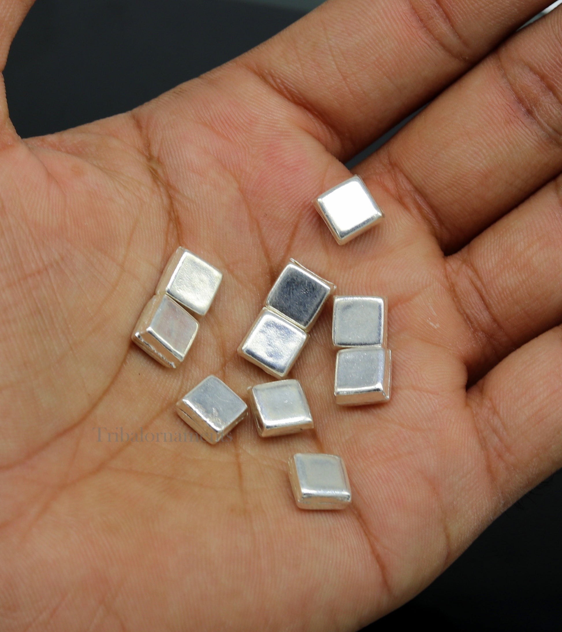 Tiny silver Barfi sweets and silver cake Prasadam for Diwali Puja, from Tribal Ornaments, traditional Indian silver worship article.