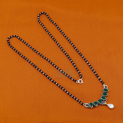 925 sterling silver mangalsutra necklace with black bead chain and green stone pendant, featuring a traditional flower design.