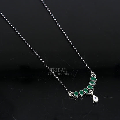 925 sterling silver black beads mangalsutra necklace with green stone and floral pendant, traditional tribal ornament style.