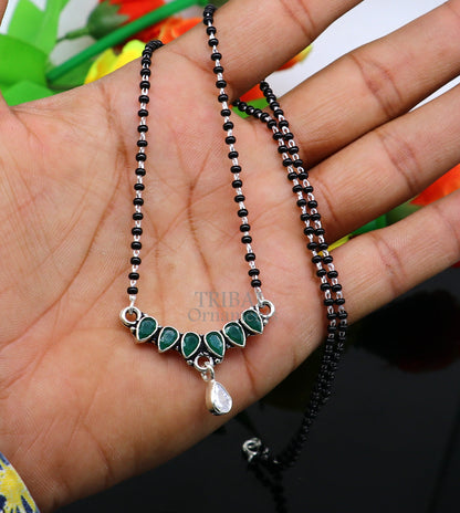 925 sterling silver black beads mangalsutra necklace with green stone and flower pendant, traditional tribal design and elegant style.