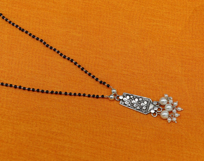 Sterling silver floral beaded chain necklace with pearl pendant, tribal-inspired design, perfect for gifting or special occasions.