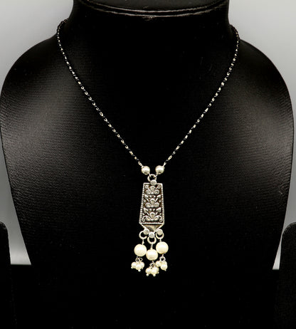 Sterling silver tribal beaded chain necklace with floral design and pearl pendant, ideal for gifting or traditional jewelry.