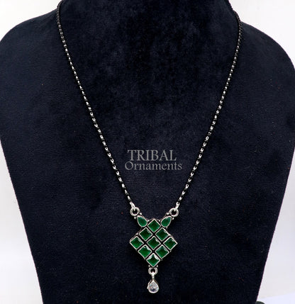 Sterling silver mangasutra necklace with green stone pendant and black beaded chain, traditional tribal jewelry for brides.