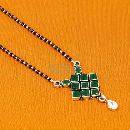 925 sterling silver mangasutra necklace with green stone pendant and black beaded chain, traditional tribal ornament design.