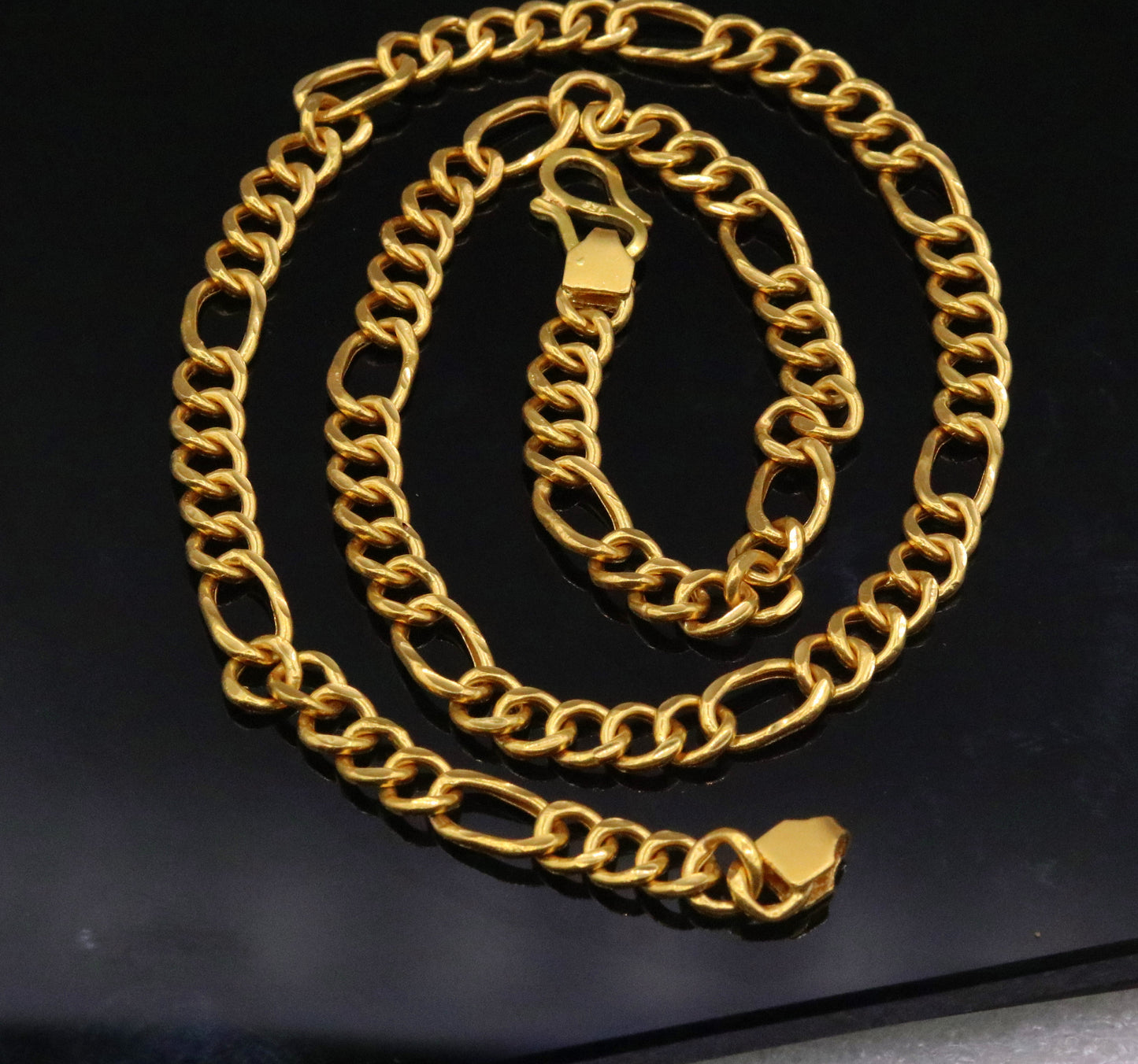 22K yellow gold handmade Figaro link chain necklace by TRIBAL ORNAMENTS, showcasing a stylish unisex design and intricate craftsmanship.