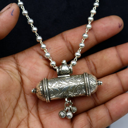 925 Sterling silver tribal pendant with intricate ethnic design, paired with a wax-filled beaded necklace in a traditional choker style.