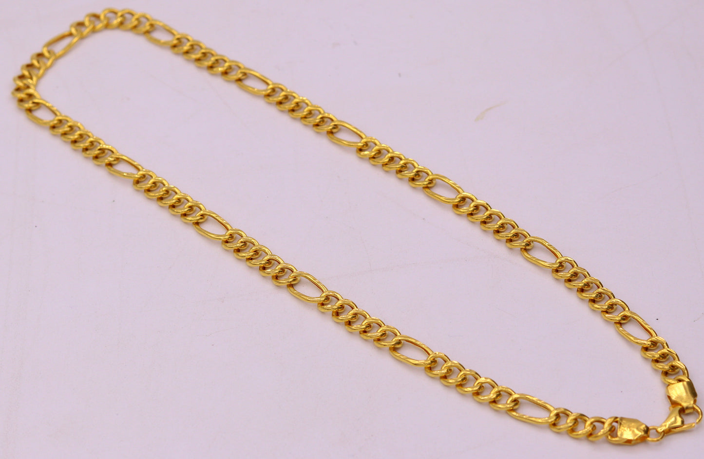 Handmade 22K yellow gold Figaro link chain necklace, 6mm wide, unisex jewelry with intricate gold links for gifting or everyday wear.