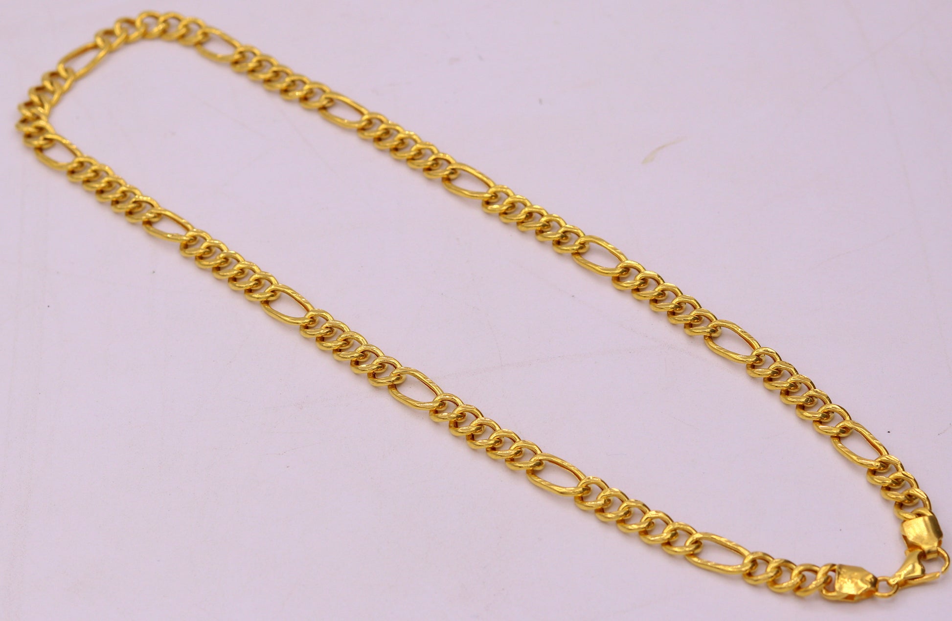 Handmade 22K yellow gold Figaro link chain necklace, 6mm wide, unisex jewelry with intricate gold links for gifting or everyday wear.