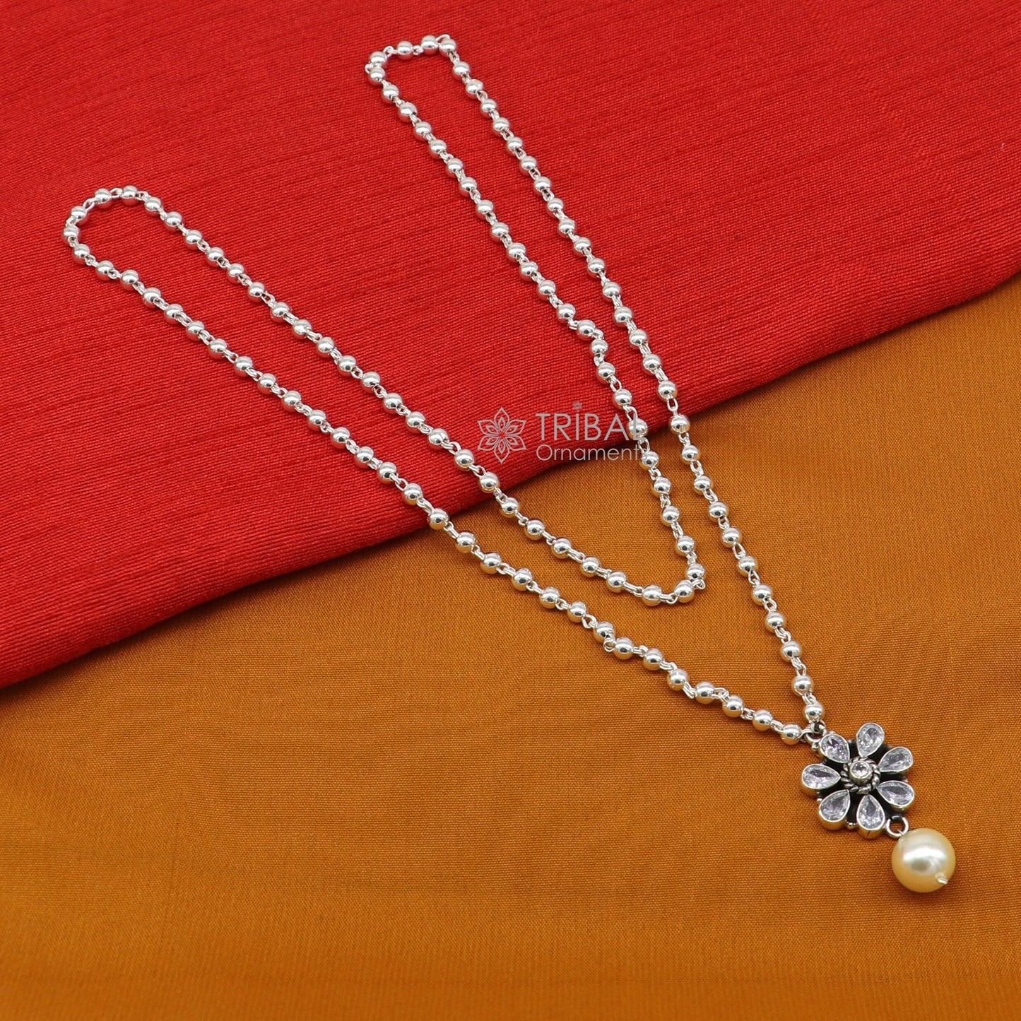 Sterling silver bead chain necklace with flower pendant and hanging pearl, part of TRIBAL ORNAMENTS jewelry set.
