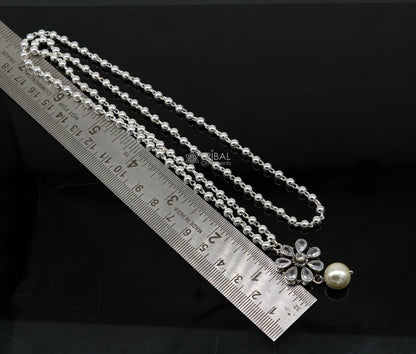 Sterling silver bead chain necklace with flower pendant and hanging pearl jewelry set, traditional tribal ornament style.