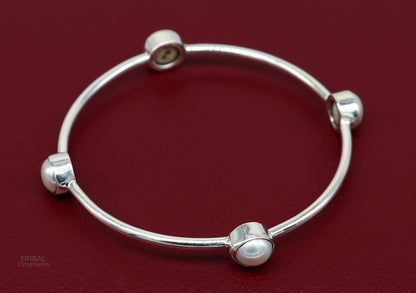 Sterling silver tribal bangle with freshwater pearl, stylish handmade jewelry by Tribal Ornaments, customized and culturally inspired.