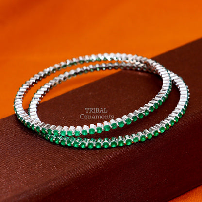Sterling silver bangle bracelet with vibrant green cubic zirconia, crafted by TRIBAL ORNAMENTS, perfect for women’s jewelry.