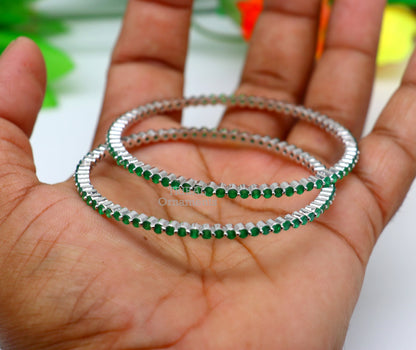 Sterling silver bangle bracelet with green cubic zirconia by TRIBAL ORNAMENTS, featuring a handcrafted, elegant jewelry design for women.