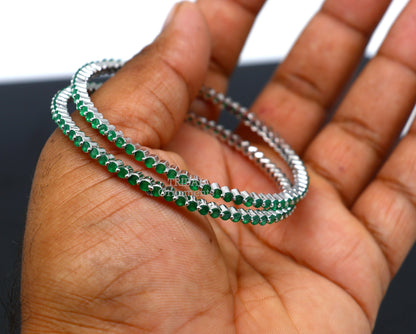 Sterling silver bangle bracelet with vibrant green cubic zirconia, handcrafted jewelry by TRIBAL ORNAMENTS for women.