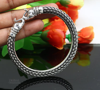 Sterling silver vintage elephant face bangle bracelet by TRIBAL ORNAMENTS, handmade Indian jewelry with intricate traditional design.