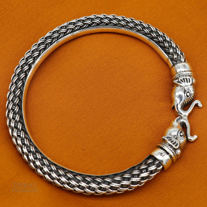 Sterling silver vintage elephant face bangle bracelet by TRIBAL ORNAMENTS, handcrafted Indian jewelry with intricate elephant design.