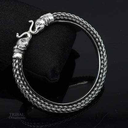 Sterling silver vintage elephant face bangle bracelet, handmade tribal jewelry from India, stylish and detailed design.