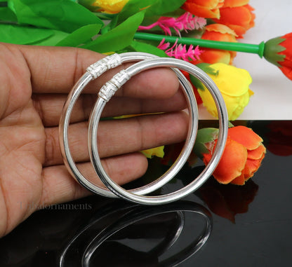 Sterling silver half-round bangle bracelet with tribal-inspired handmade design, featuring intricate patterns and a stylish look.