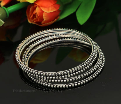 Sterling silver designer bangle bracelet with waved silver balls by Tribal Ornaments, stylish jewelry for gifting or brides.