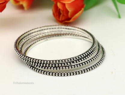 Sterling silver bangle bracelet with waved silver balls designed by TRIBAL ORNAMENTS, stylish jewelry for gifting or brides.