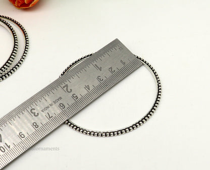 Sterling silver designer bangle bracelet with wavy silver ball accents from TRIBAL ORNAMENTS. Stylish jewelry for women.