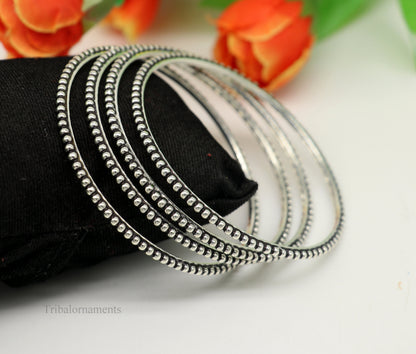 Sterling silver bangle bracelet with customized waved silver balls design by Tribal Ornaments, stylish designer jewelry for gifting.