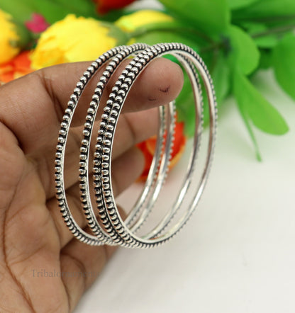 Sterling silver bangle bracelet with waved silver balls, stylish designer jewelry by TRIBAL ORNAMENTS, perfect for gifting or brides.