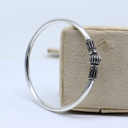 Sterling silver single ball bangle bracelet with shiny finish, stylish bridal jewelry, designed by TRIBAL ORNAMENTS.