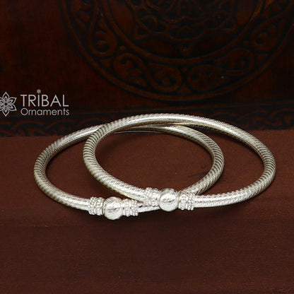 Sterling silver bangle bracelet with customized tribal design, featuring intricate patterns, from TRIBAL ORNAMENTS jewelry collection.