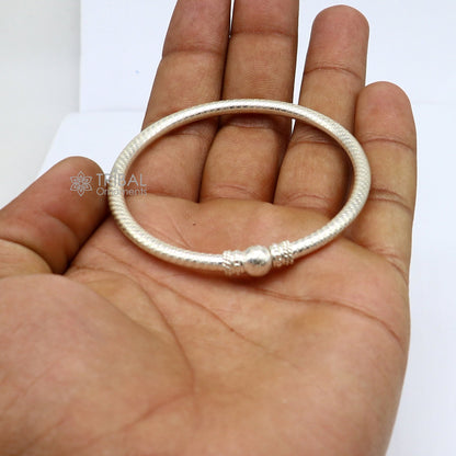 Sterling silver bangle bracelet by TRIBAL ORNAMENTS featuring a customized tribal design, perfect as gift jewelry.