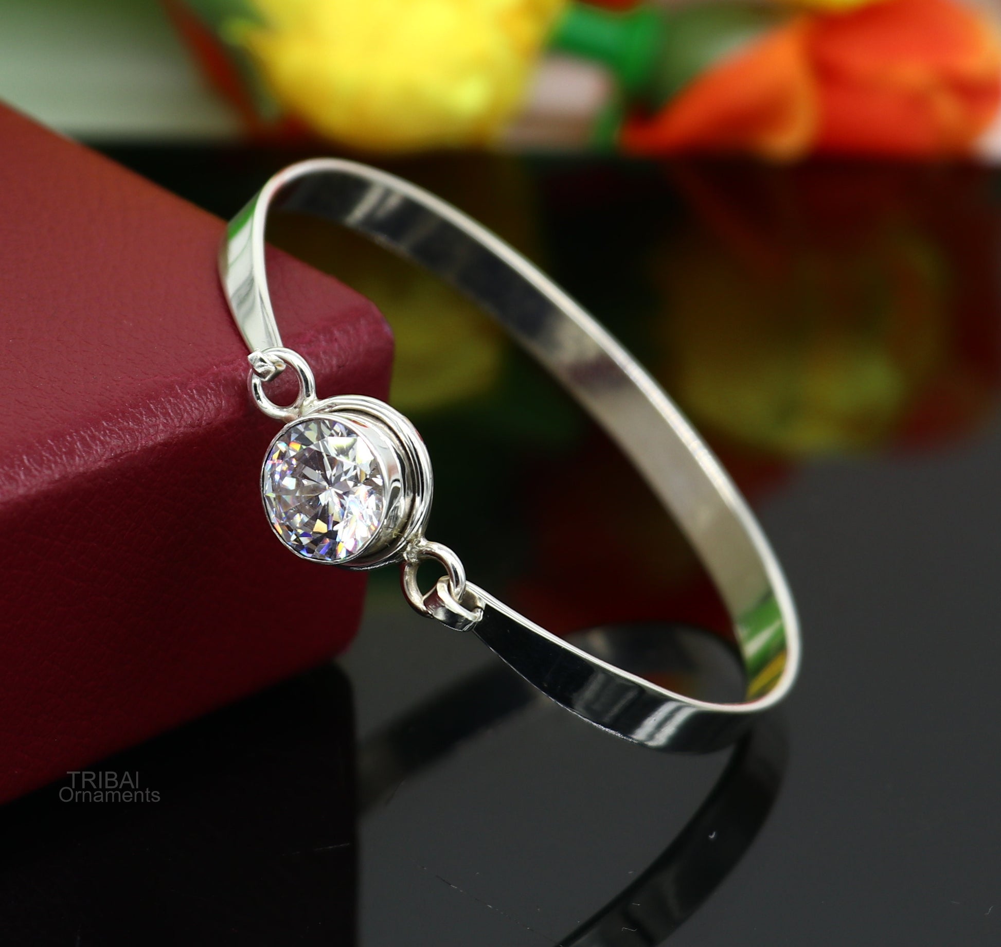 Elegant 925 sterling silver bangle bracelet with cubic zircon stones, featuring intricate design, perfect for gifting or stylish wear.