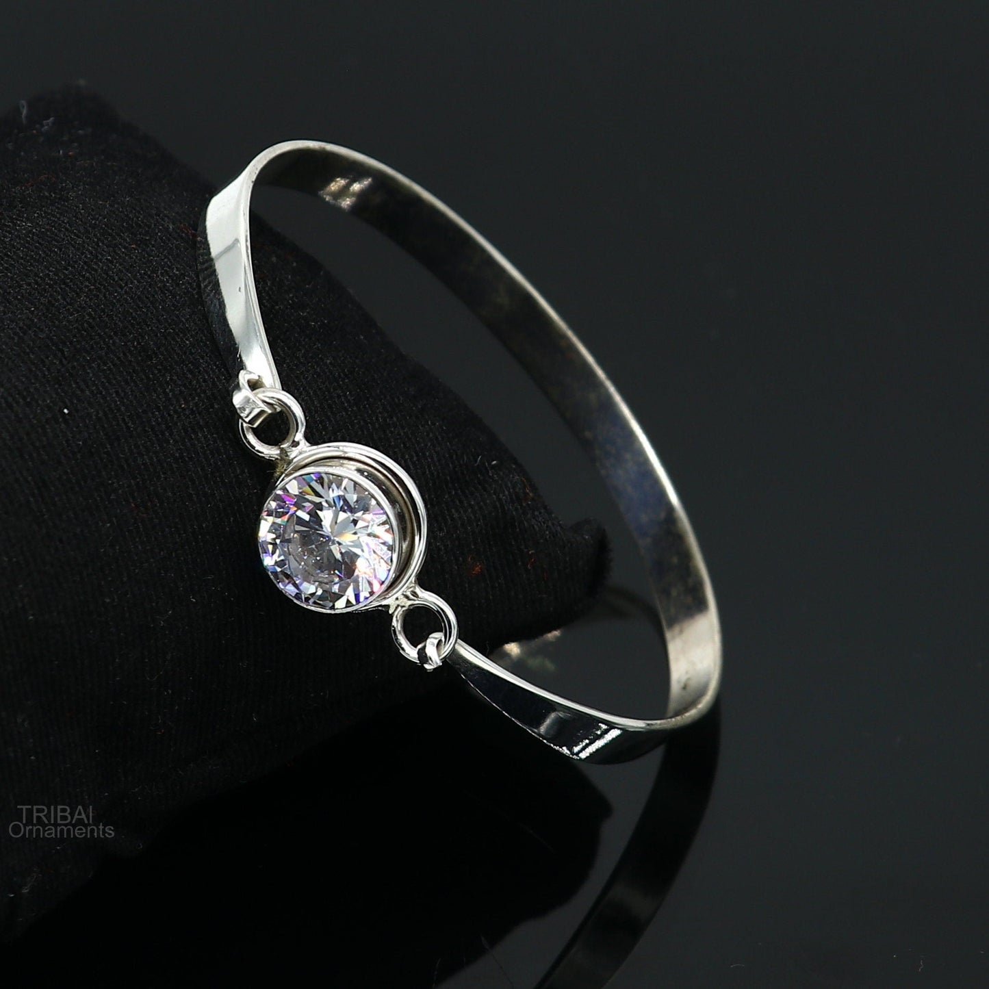 Elegant 925 sterling silver bangle bracelet with cubic zirconia stones, featuring a sleek design ideal for gifting or stylish wear.