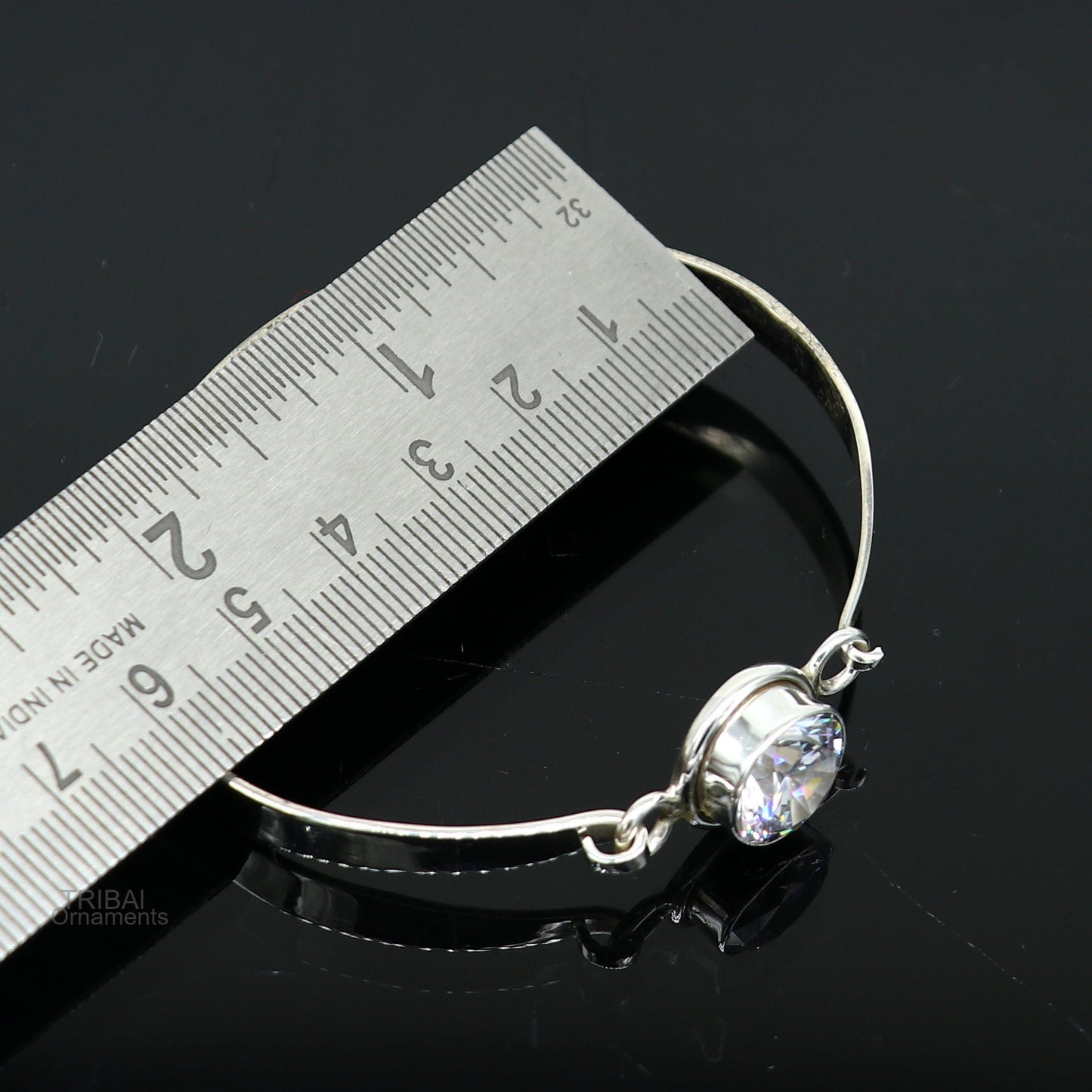 Elegant 925 sterling silver cubic zirconia bangle bracelet with intricate design, perfect for gifting or stylish wear.
