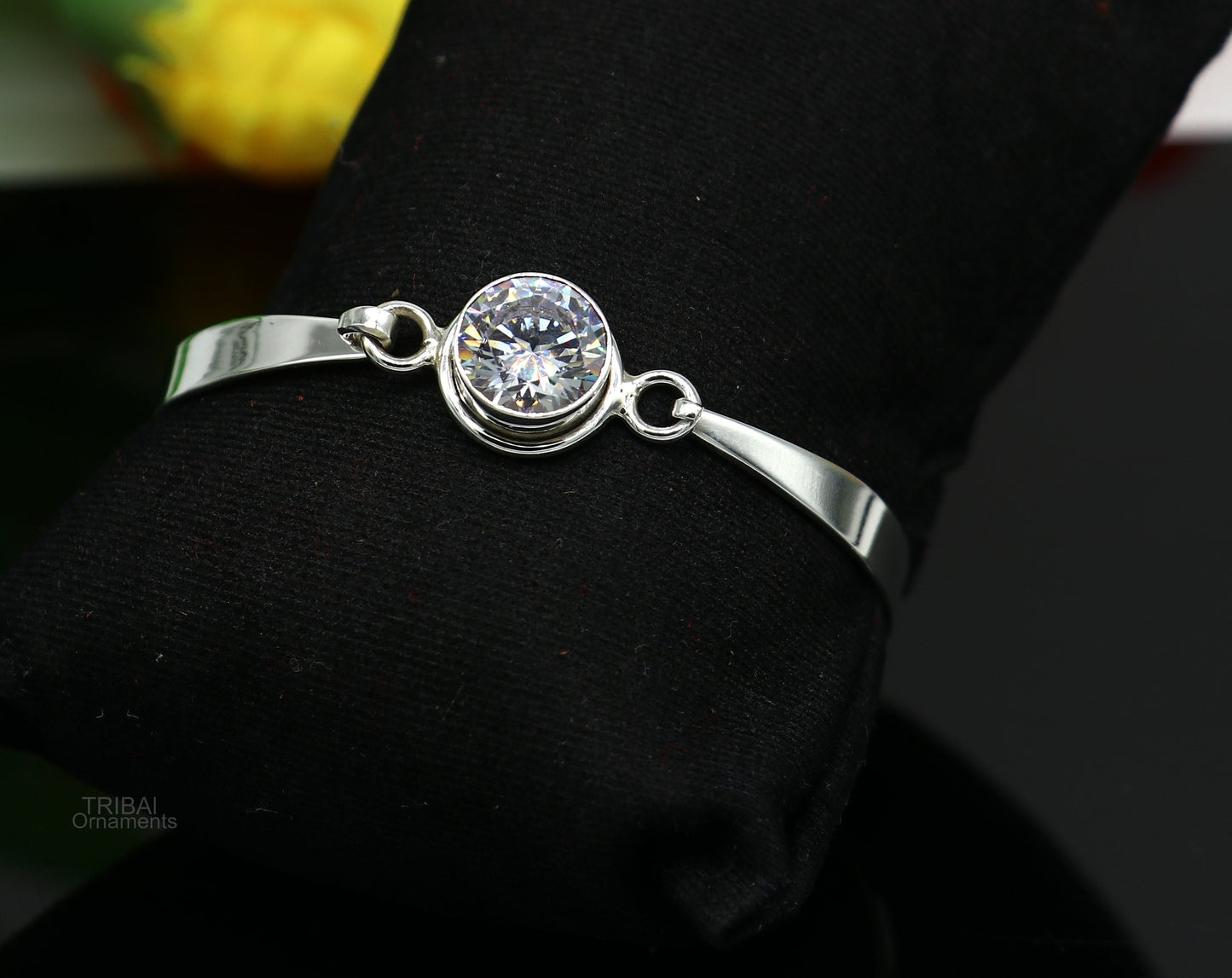 Elegant 925 sterling silver bangle bracelet with cubic zircon stones, featuring a sleek design perfect for gifting or stylish wear.
