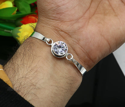 Elegant 925 sterling silver bangle bracelet with cubic zirconia stones, featuring a delicate design ideal for gifting or everyday wear.