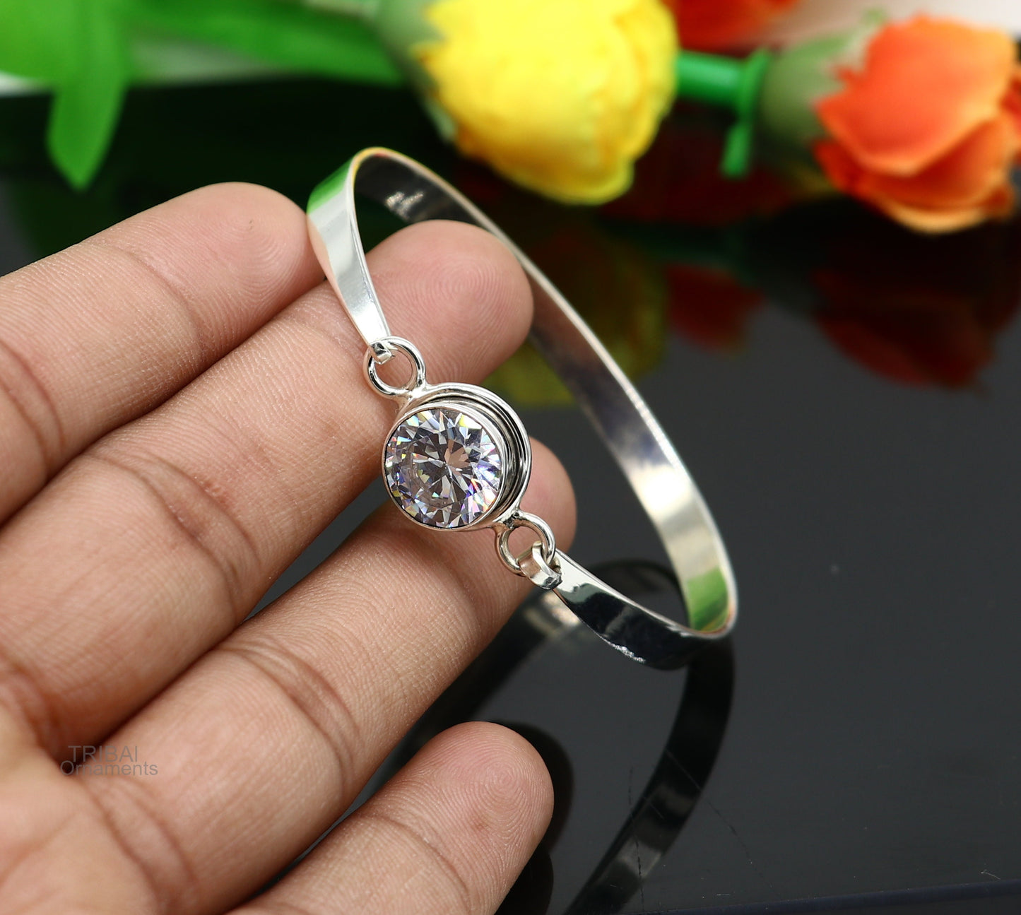 Elegant 925 sterling silver bangle bracelet with cubic zircon stones, featuring a delicate design perfect for stylish gift-giving.