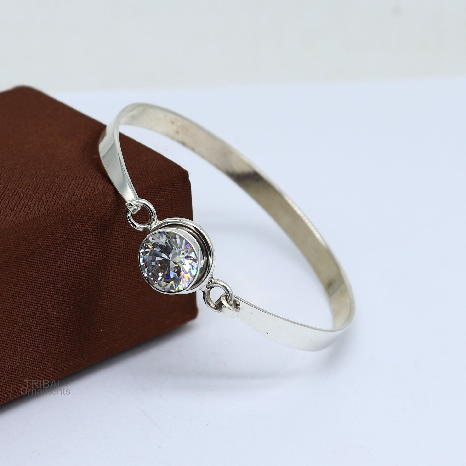 Elegant 925 sterling silver cubic zirconia bangle bracelet with intricate design, perfect for gifting or stylish wear.