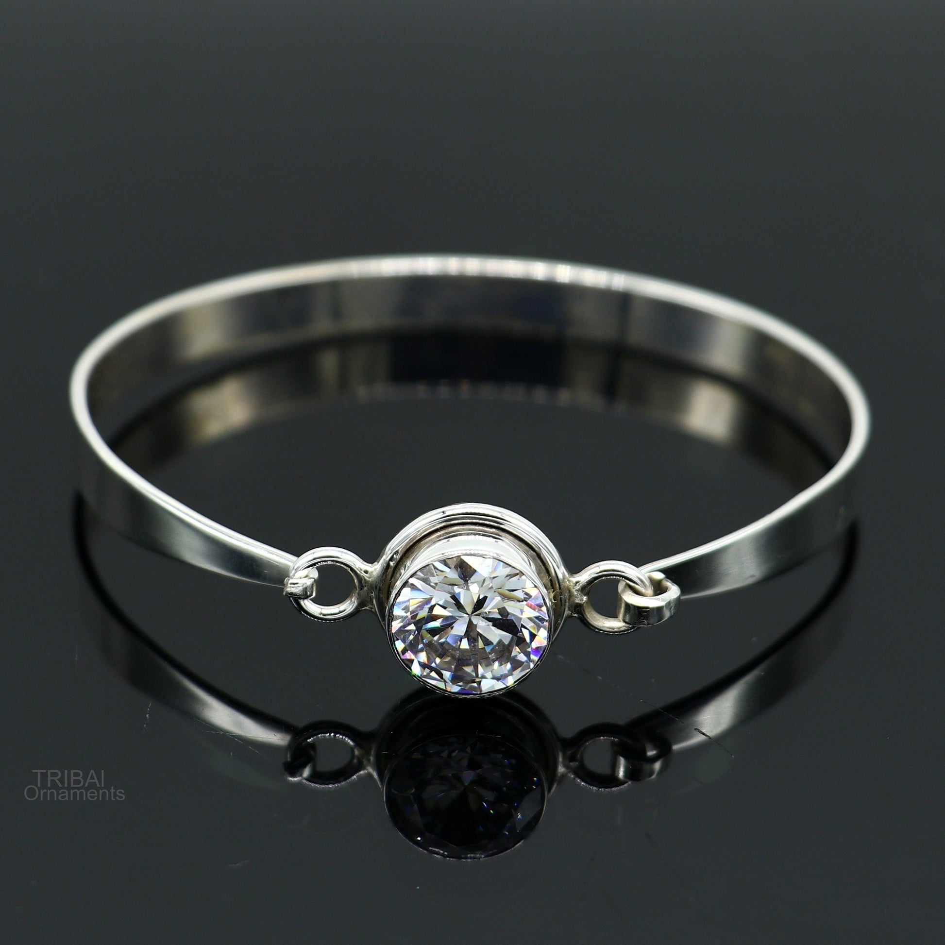 Elegant 925 sterling silver bangle bracelet with cubic zirconia stones, featuring intricate tribal-inspired design, perfect for gifting.